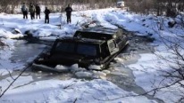 Insane Russian Guy Drives His ATV Through a Frozen River and Breaks the Ice