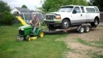 John Deere GT225 Lawn Tractor Pulls the Huge Ford F350 Truck and the Trailer